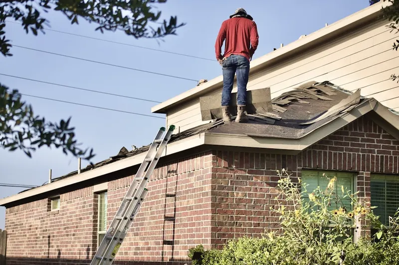 Professional roofer working on a residential roof in Twin Creeks at Mendenhall